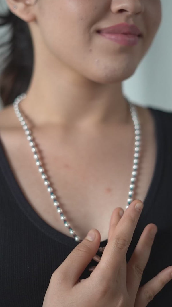 Pearl and bead necklace worn by woman
