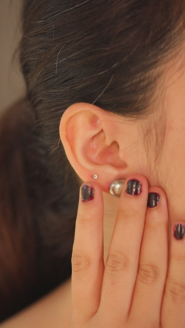 Close-up of ear with small diamond stud earring