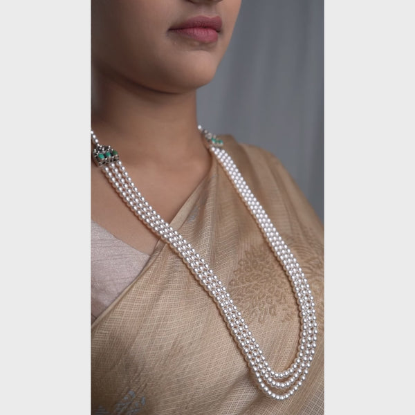 Elegant pearl necklace with carved findings and green semi-precious stones