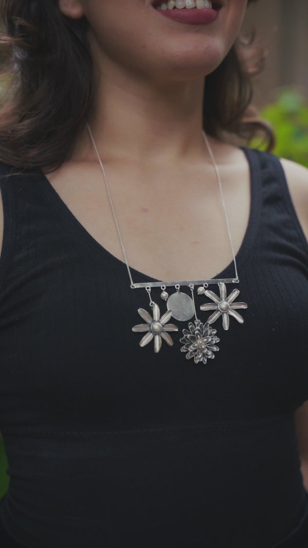 Detail shot of filigree snowflake motif and pearl latkan