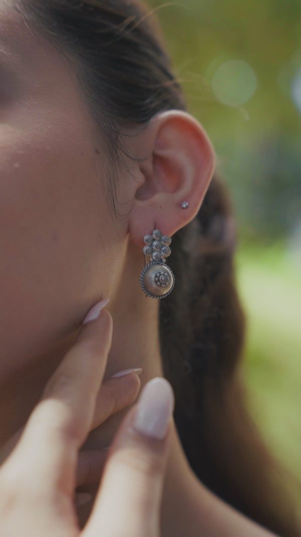 Silver traditional earrings with floral and circular design