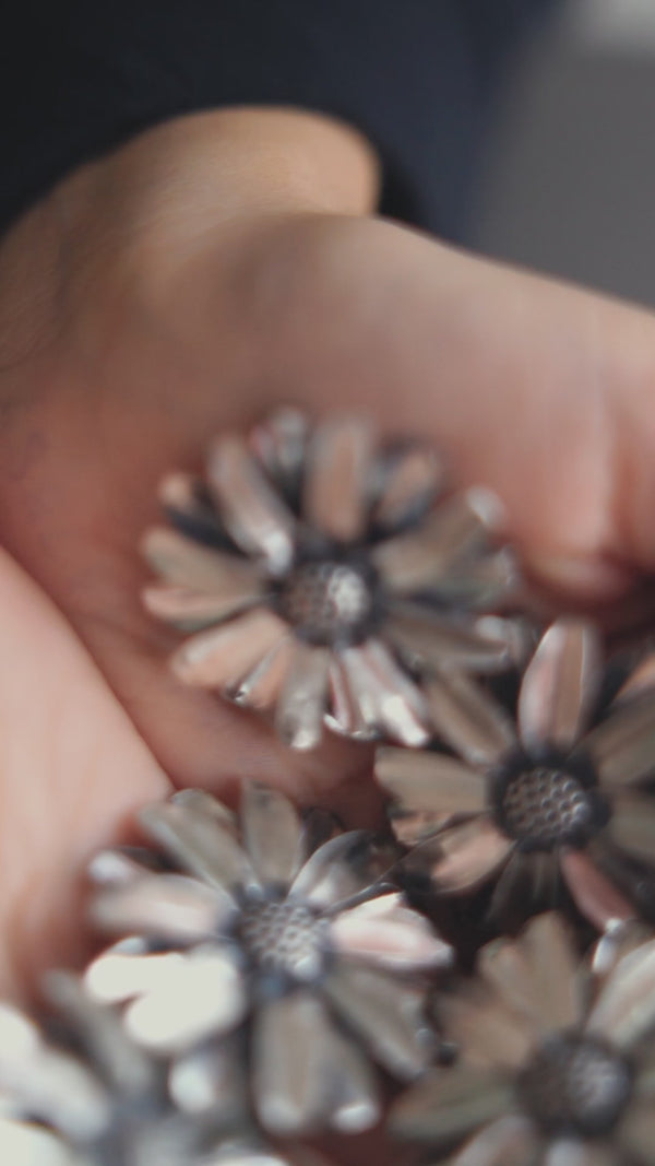 a person holding a bunch of flowers in their hands