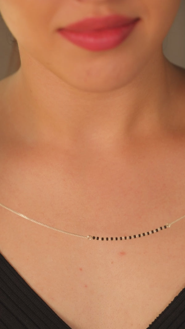 Silver mangalsutra with black beads detailing