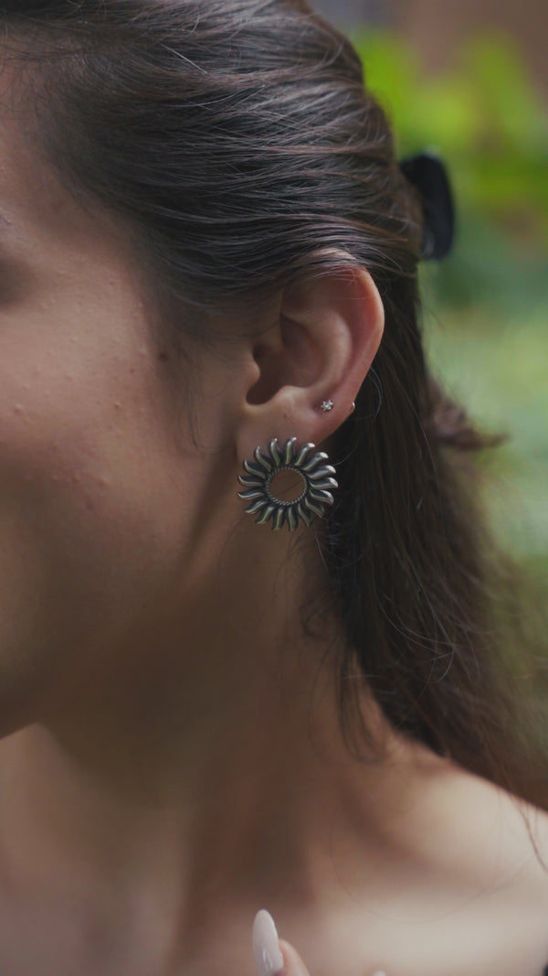 Sun-inspired sterling silver earrings with intricate design