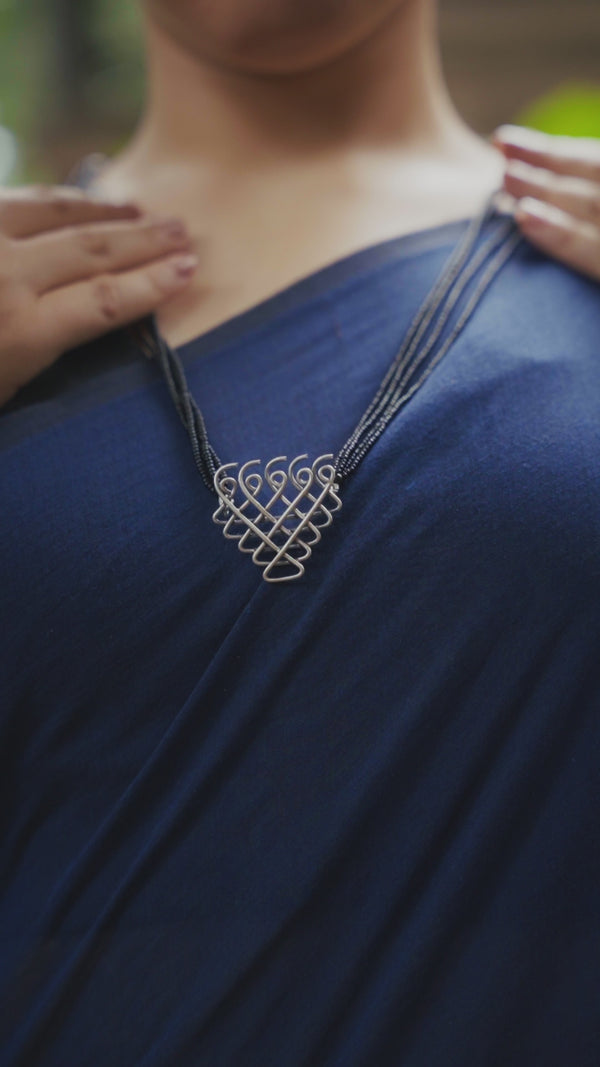 Silver Saraswati Mangalsutra with black beads on navy saree