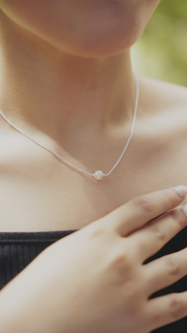 Pearl necklace with single pearl on silver chain