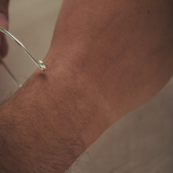 Silver bracelet on white jewelry display