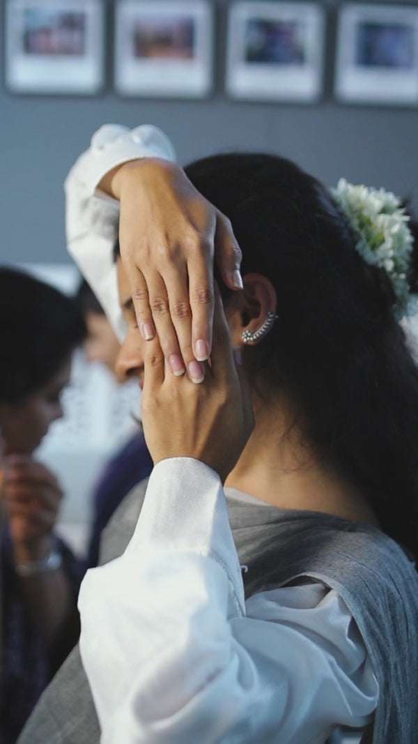 Elegant woman with floral hair accessory and silver ear cuff