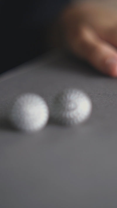 three white balls are sitting on a table