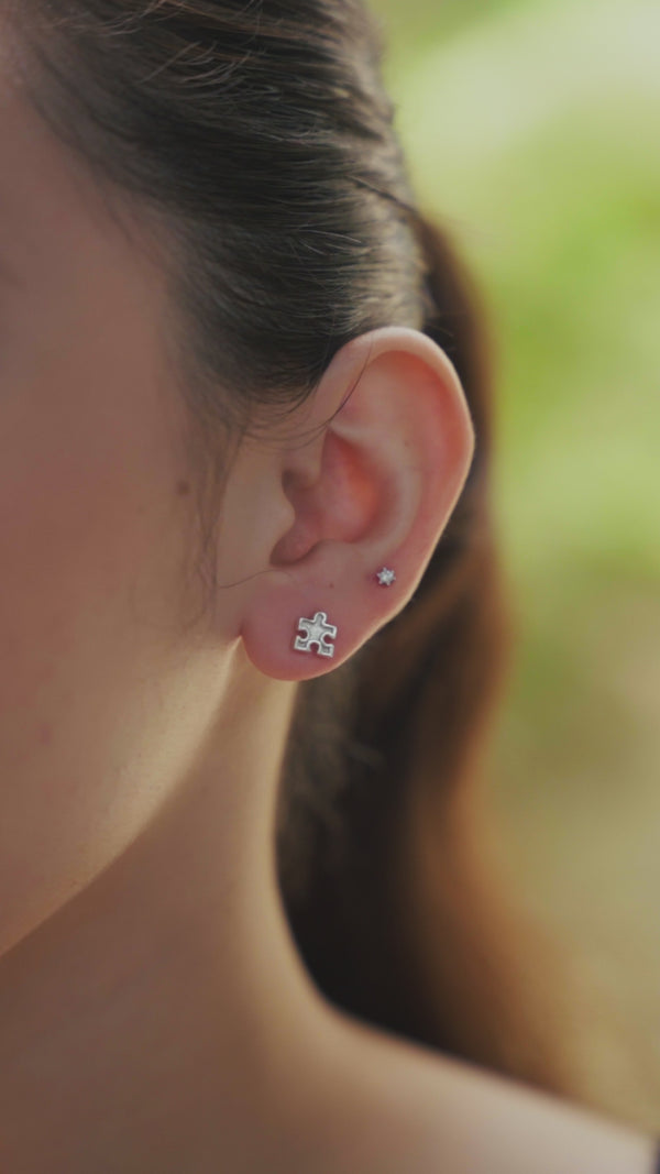 Silver puzzle piece and star earrings