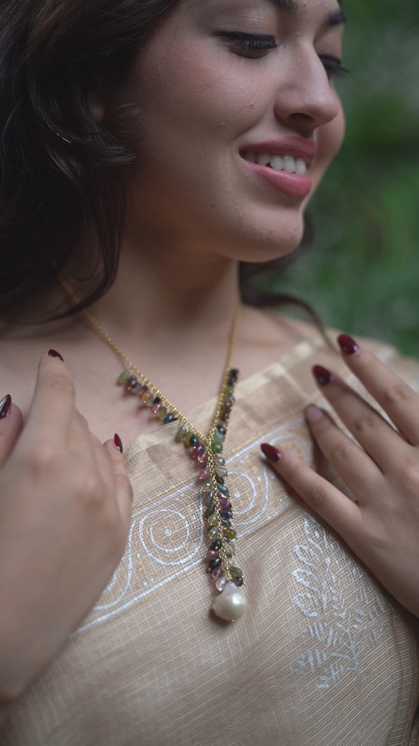 Woman wearing colorful gemstone and pearl necklace