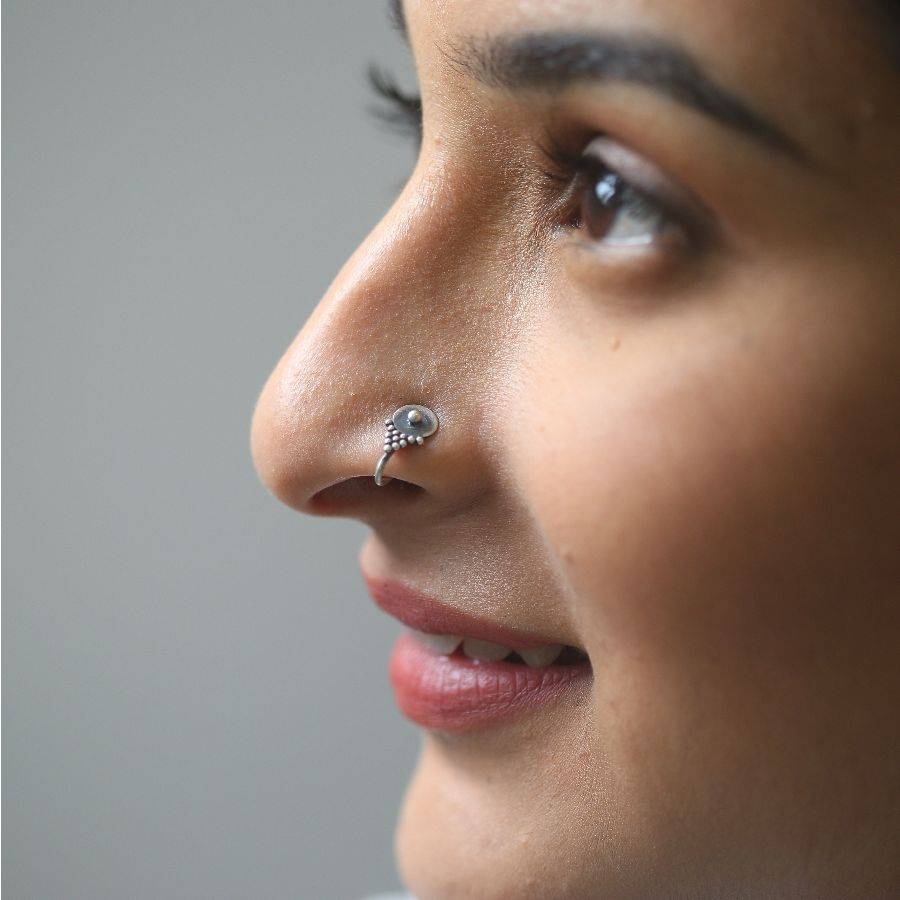 a woman with a nose piercing on her nose