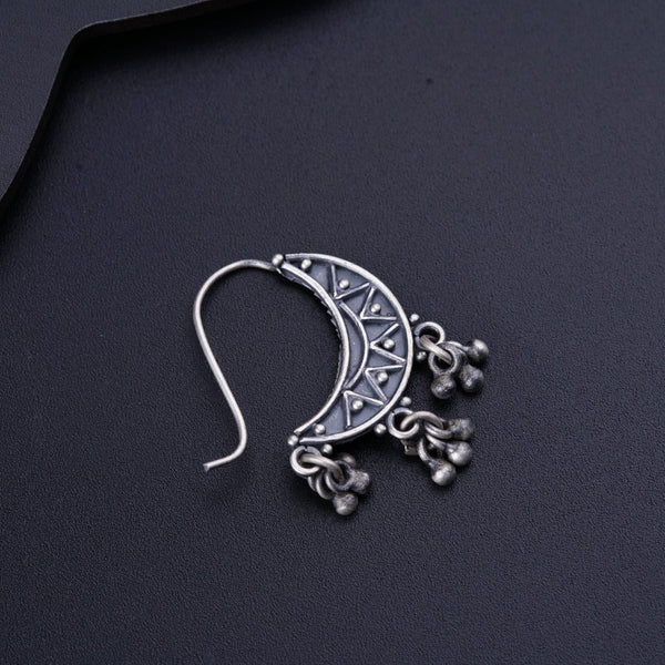 a close up of a pair of earrings on a black surface
