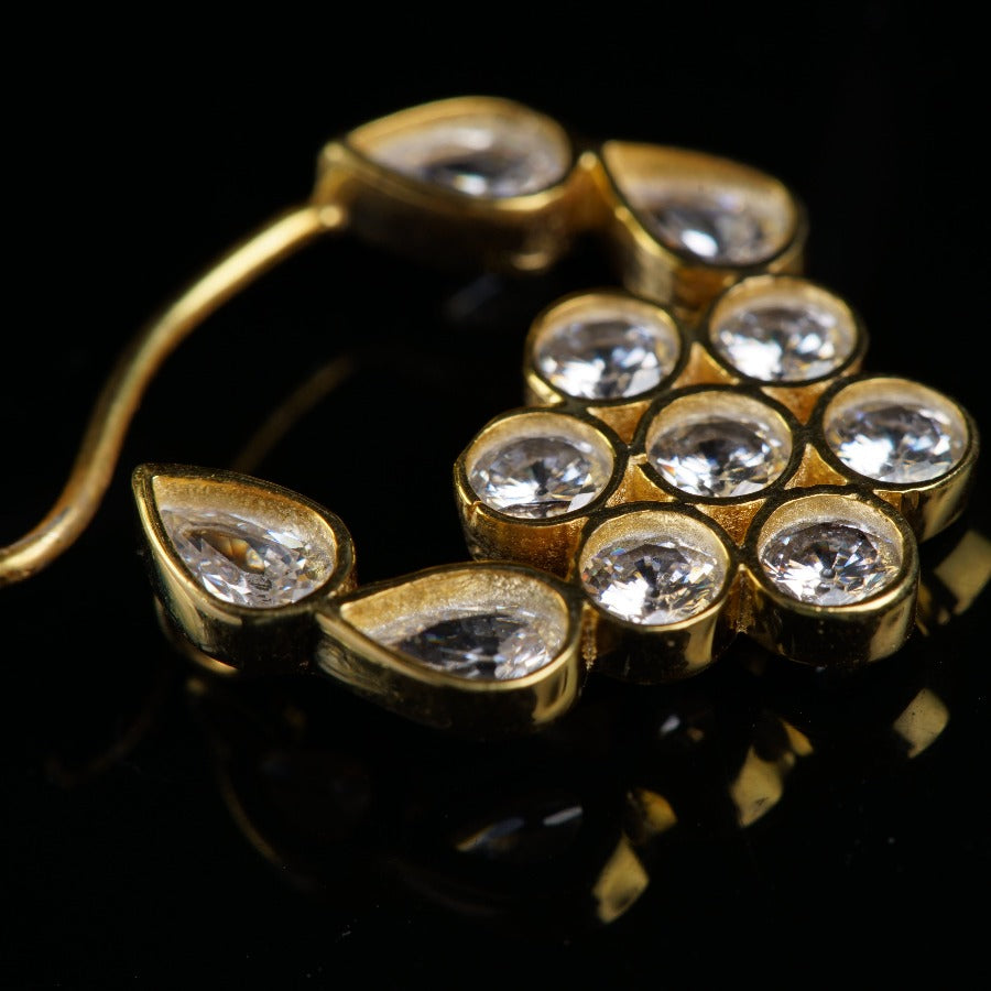 a close up of a gold brooch with diamonds