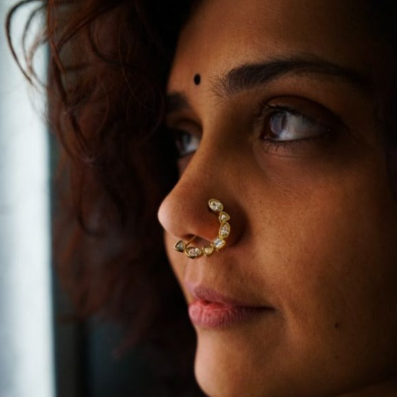 a close up of a woman with a nose ring