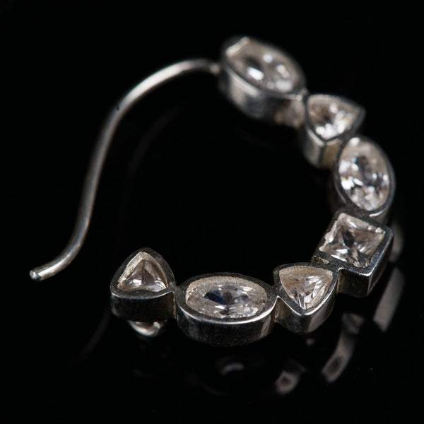 a close up of a metal object on a black surface
