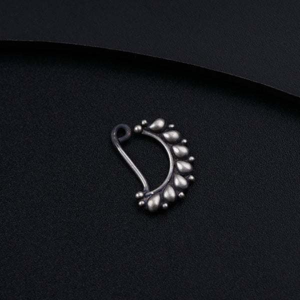 a close up of a metal object on a black surface