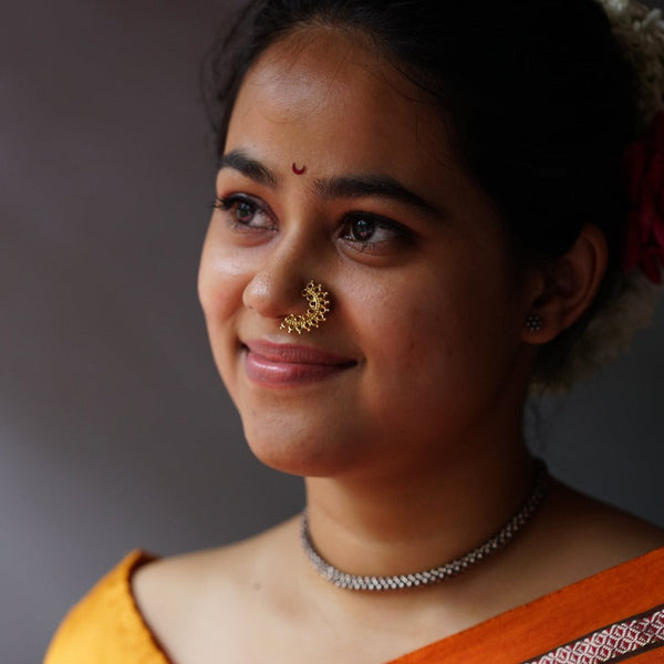 a woman with a nose ring and a necklace
