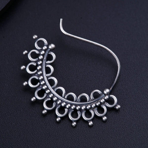 a close up of a pair of earrings on a black surface