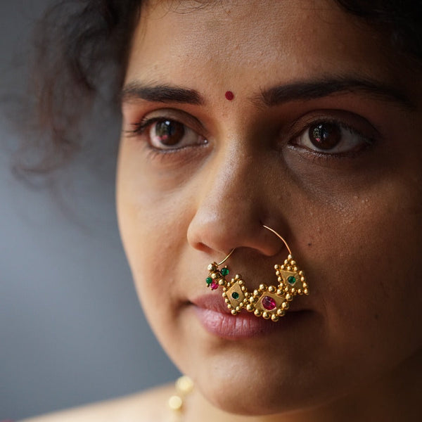 a close up of a woman with a nose ring