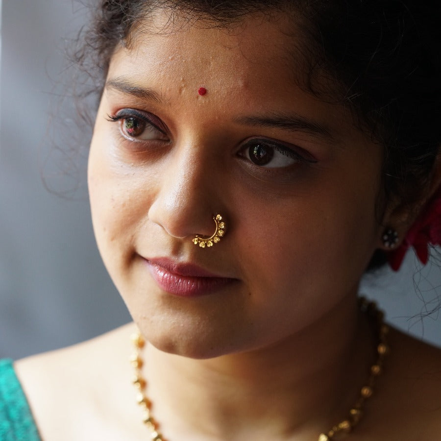 a close up of a woman with a nose ring