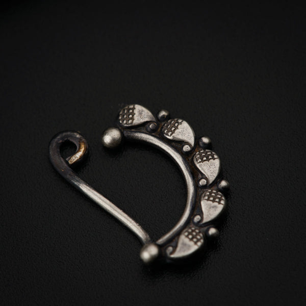a pair of silver colored metal hooks on a black surface