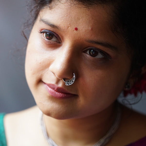 a close up of a woman with a nose ring