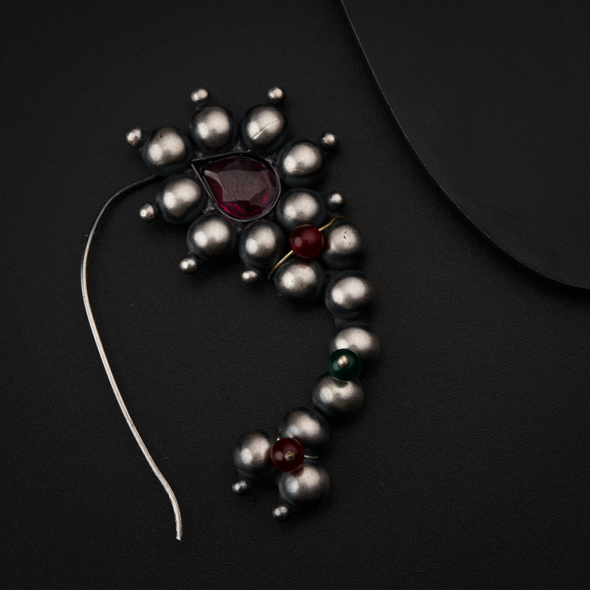 a necklace with pearls and a glass bead