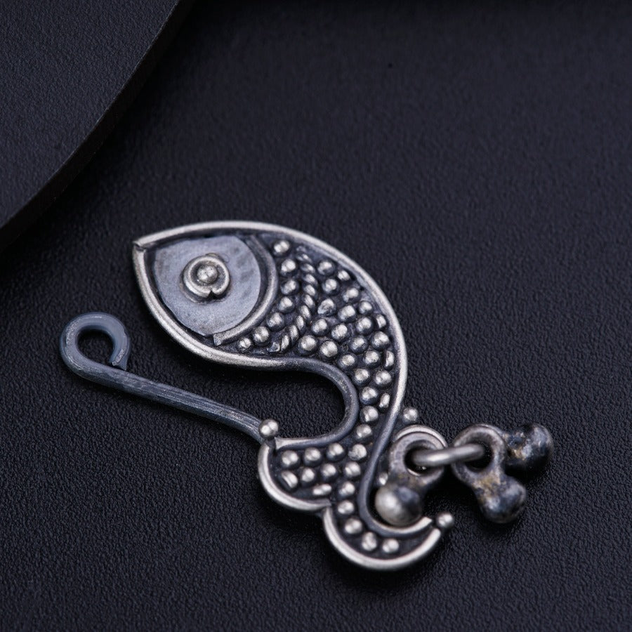 a metal hook with a fish design on it