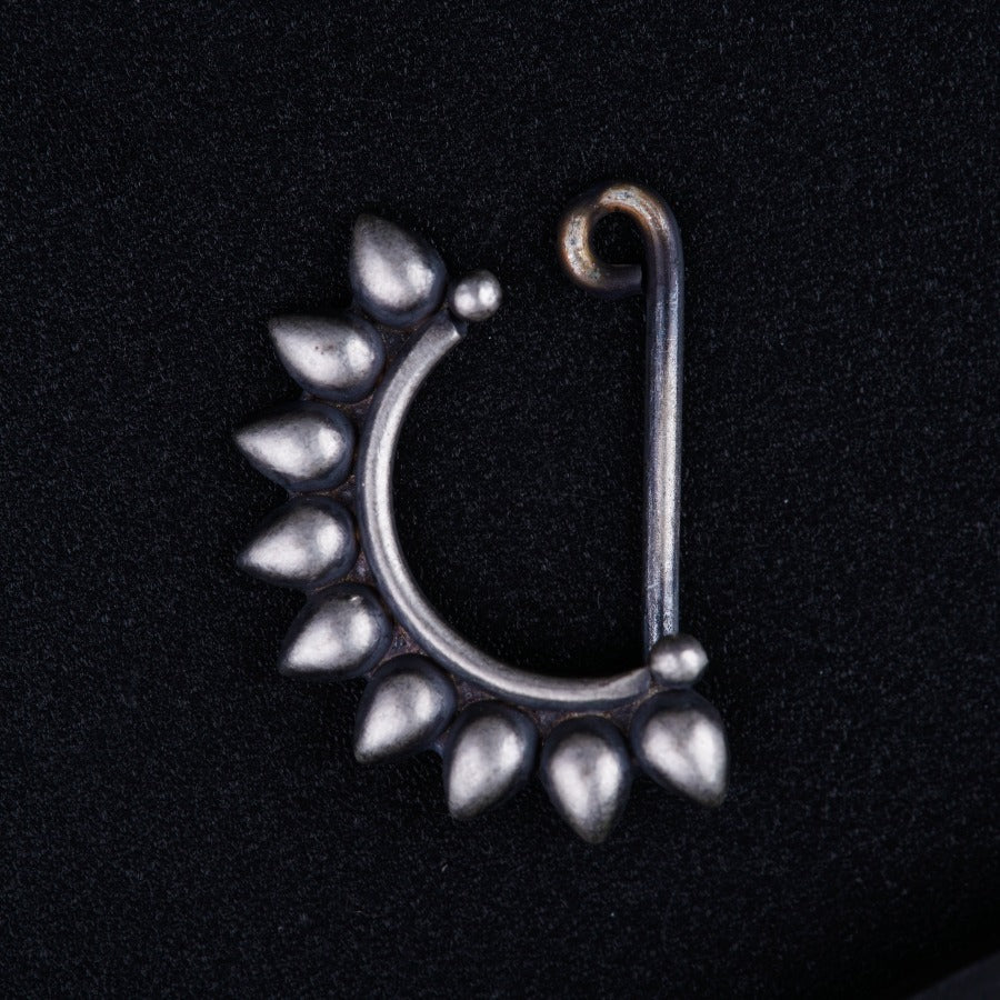a silver nose ring with leaves on it