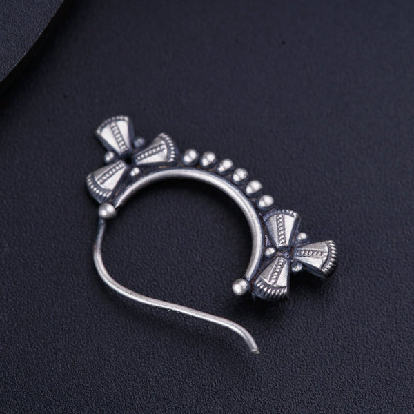 a close up of a metal object on a black surface