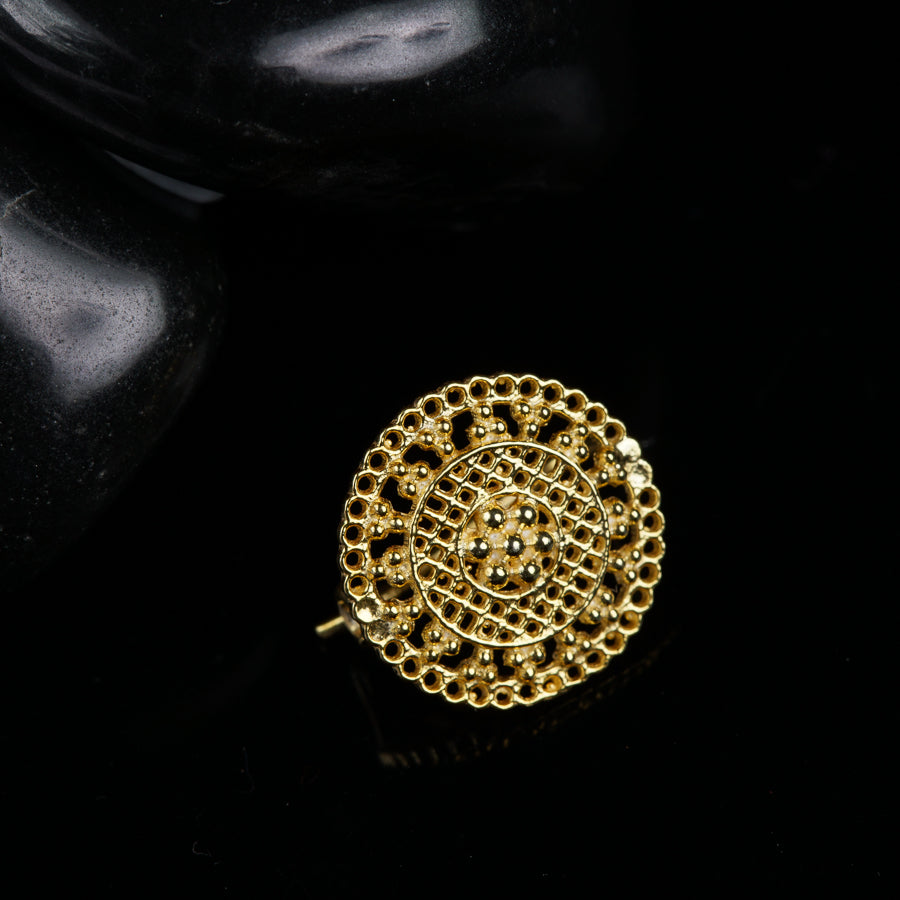 a close up of a gold ring on a black surface