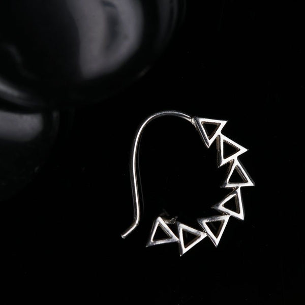 a pair of earrings sitting on top of a table