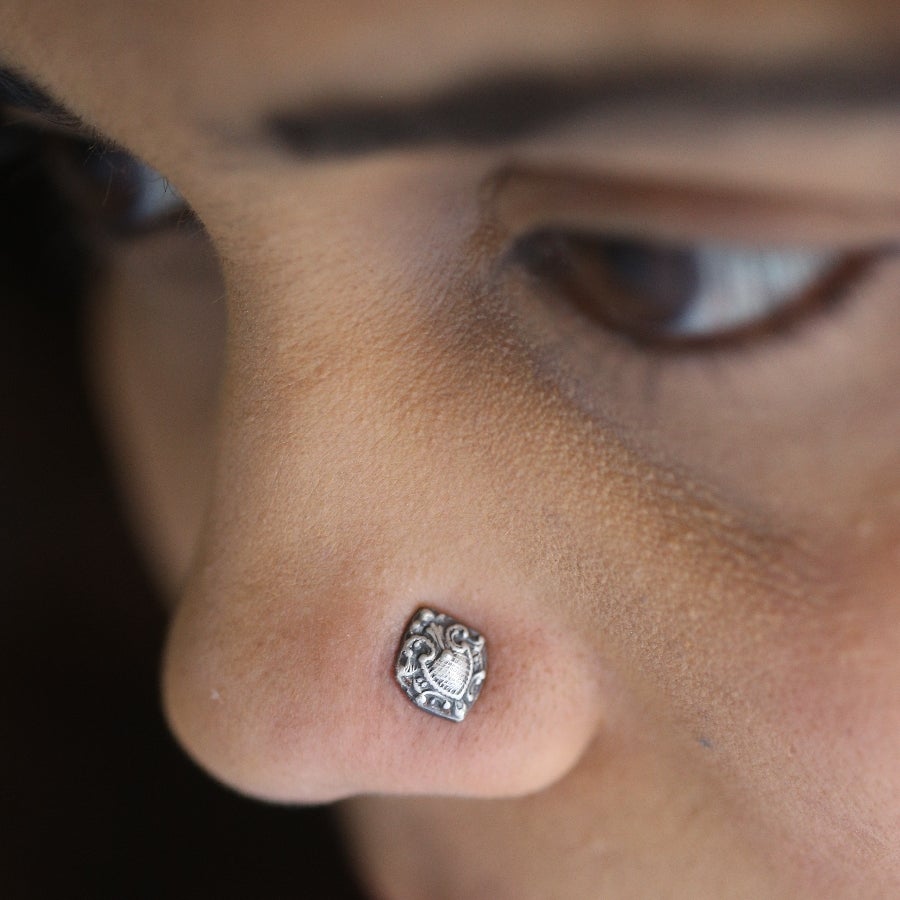 a close up of a person with a nose piercing