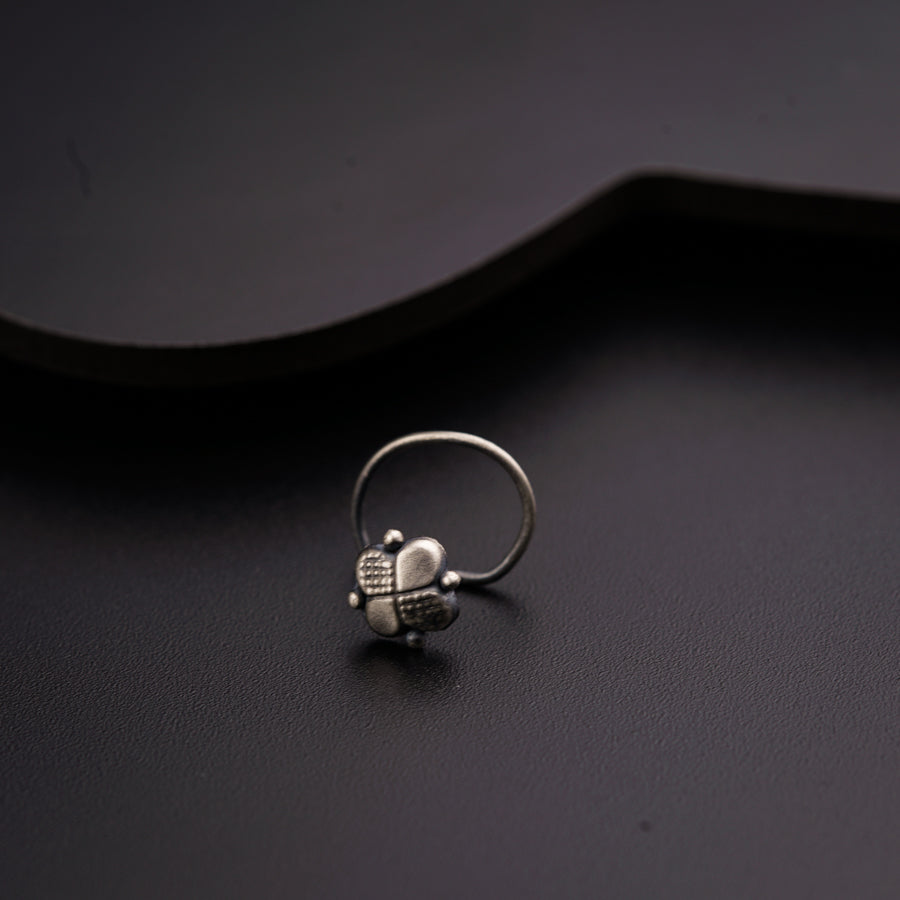 a skull ring sitting on top of a black surface
