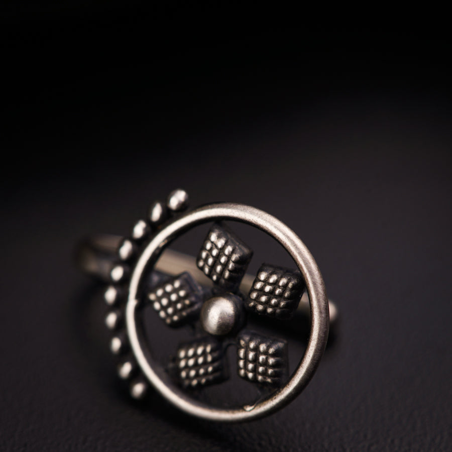 a silver ring with four dices on it