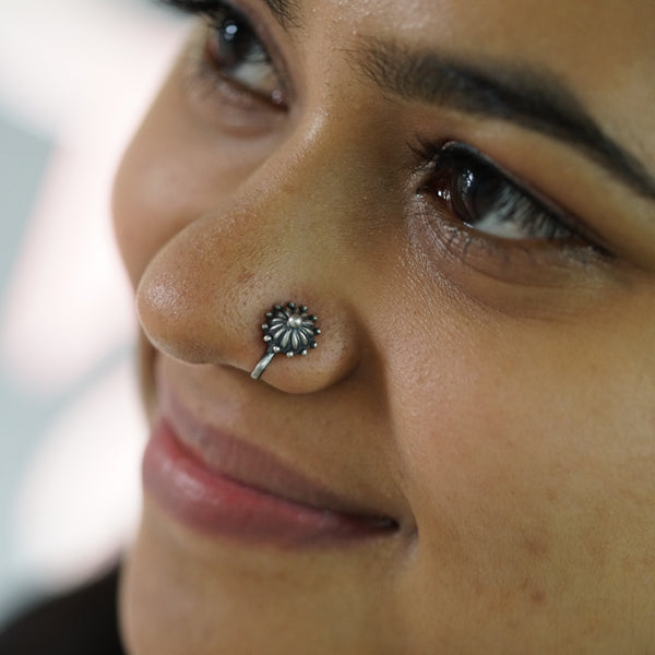 a close up of a person with a nose ring