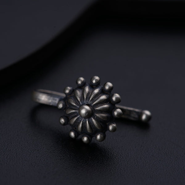 a close up of a ring on a black surface