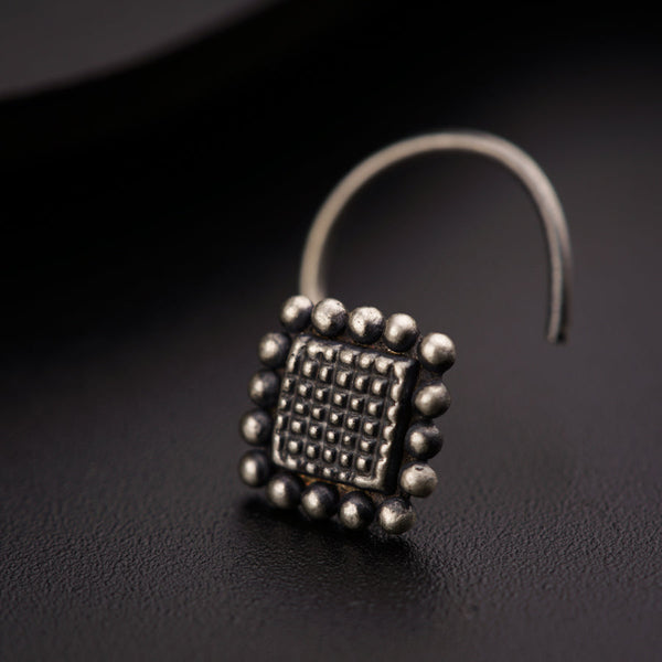 a close up of a metal object on a black surface