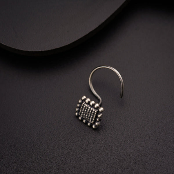 a pair of earrings sitting on top of a table