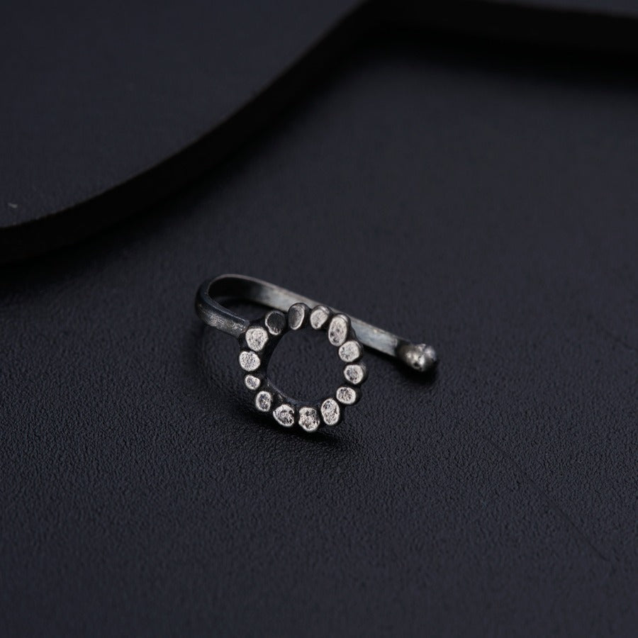 a diamond ring sitting on top of a black surface
