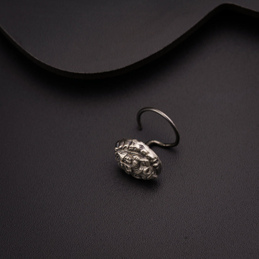 a silver ring sitting on top of a black surface