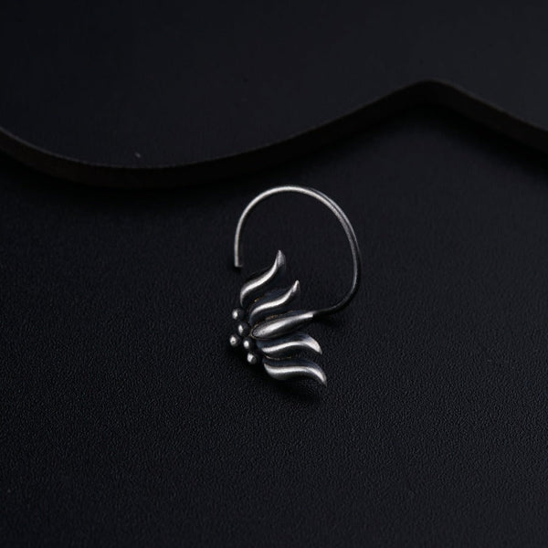 a close up of a metal object on a black surface