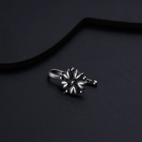 a ring sitting on top of a black surface