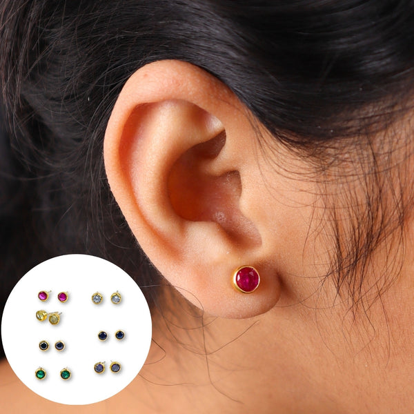 Close-up of red gemstone stud earring on ear