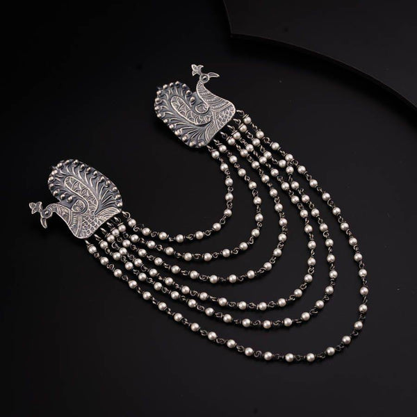 a necklace with pearls and a bird on it