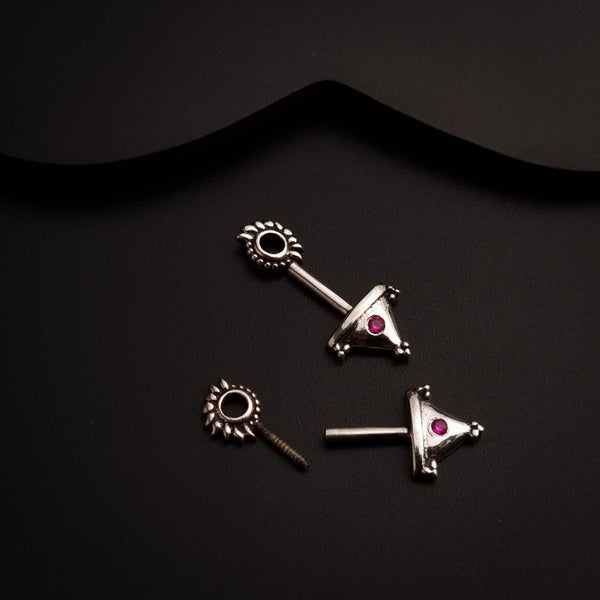 a pair of silver earrings with pink stones