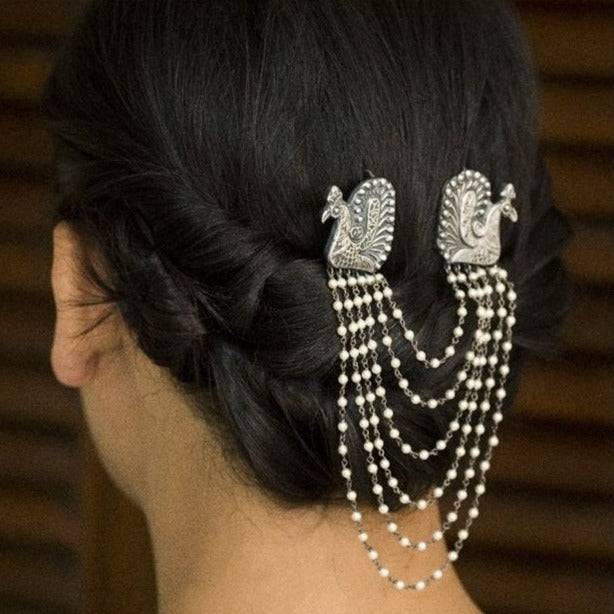 a close up of a woman's hair with pearls