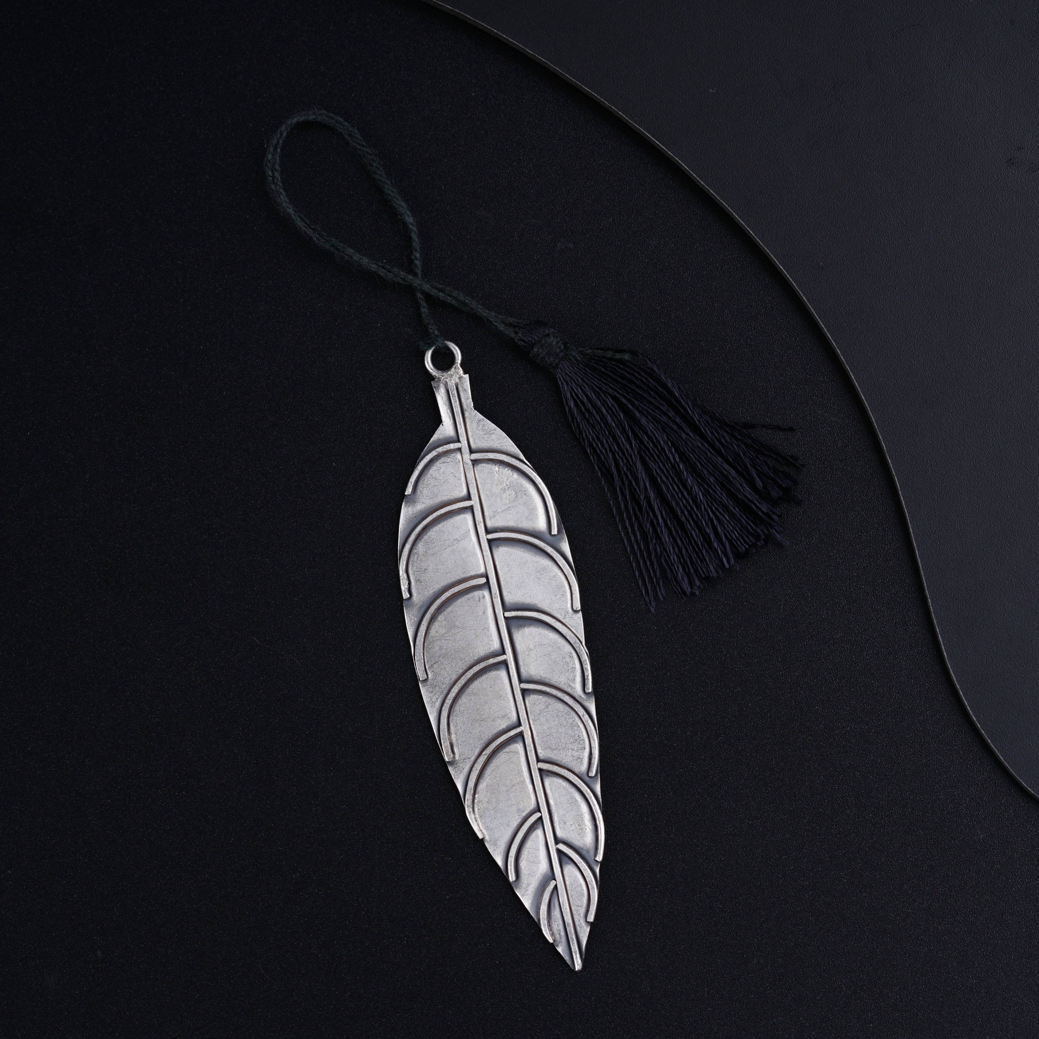 a black and white feather with a tassel