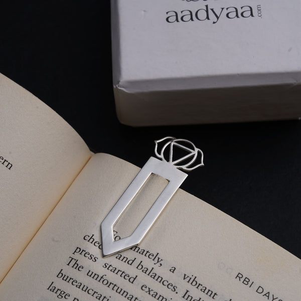 an open book with a metal object on top of it